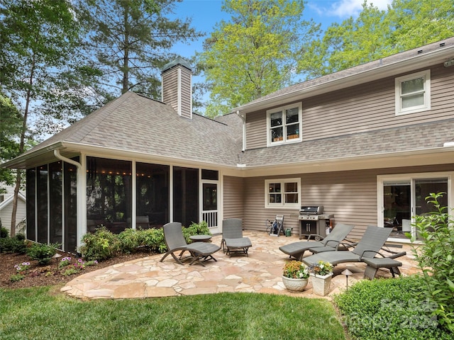 back of house featuring a patio and a sunroom