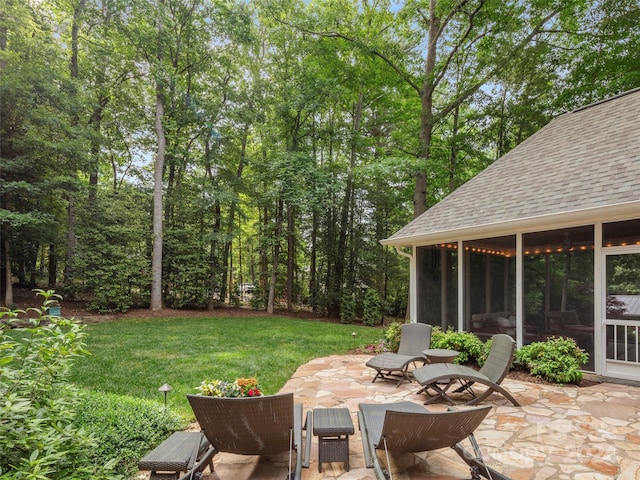 view of yard featuring a patio and a sunroom