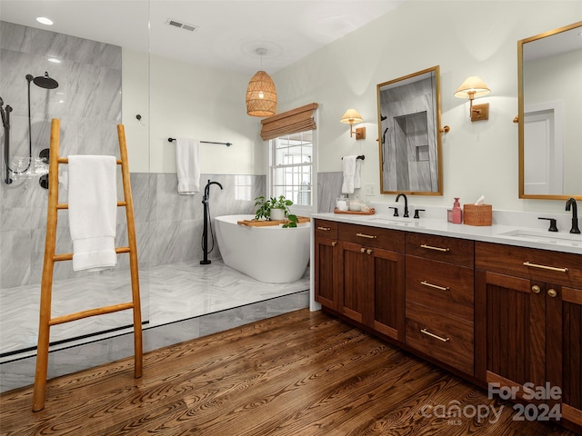 bathroom featuring vanity, separate shower and tub, hardwood / wood-style flooring, and tile walls