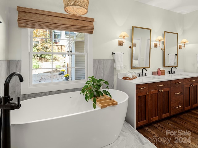 bathroom with vanity, a bathtub, and hardwood / wood-style flooring