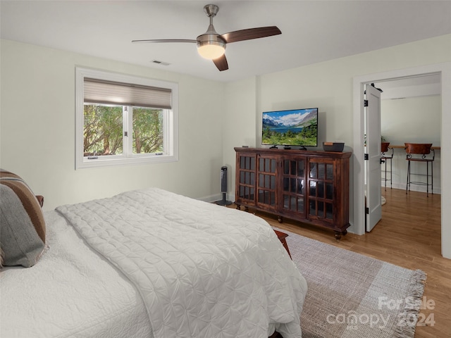 bedroom with hardwood / wood-style floors and ceiling fan