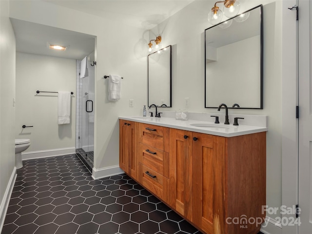 bathroom featuring vanity, a shower with shower door, toilet, and tile patterned flooring