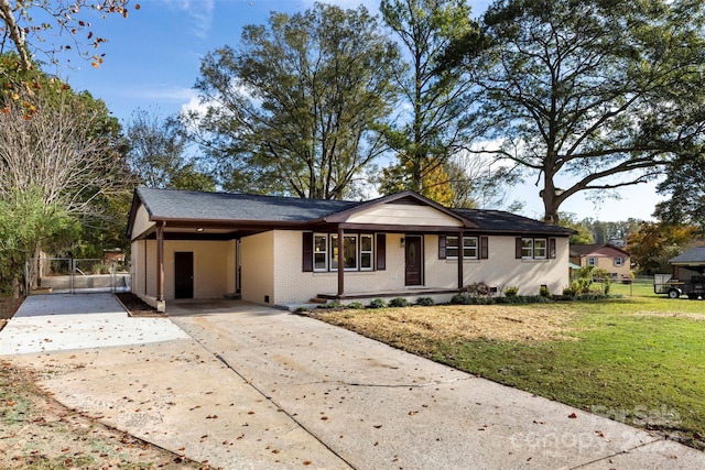 ranch-style house featuring a carport and a front yard