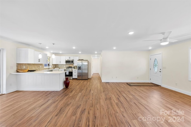 kitchen featuring appliances with stainless steel finishes, kitchen peninsula, light hardwood / wood-style floors, decorative light fixtures, and white cabinets