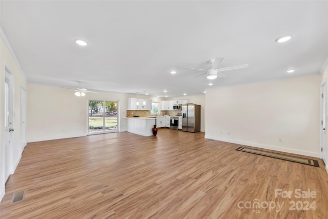 unfurnished living room with ceiling fan, ornamental molding, and light wood-type flooring