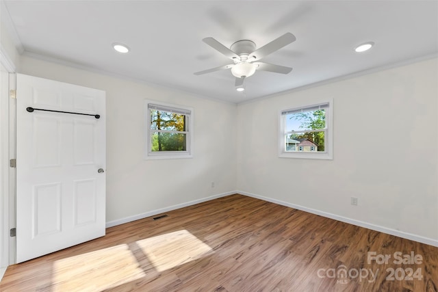 unfurnished room featuring crown molding, light hardwood / wood-style flooring, and plenty of natural light