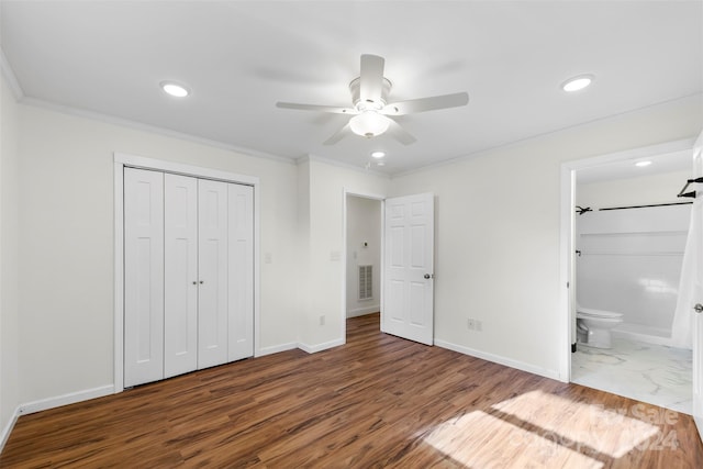 unfurnished bedroom with crown molding, dark hardwood / wood-style floors, a closet, and ceiling fan