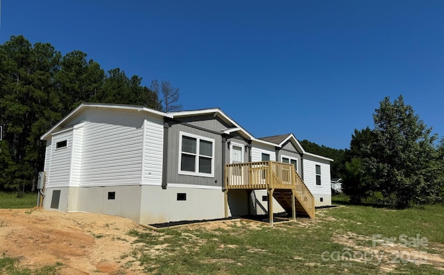 view of home's exterior featuring crawl space, stairs, a deck, and a yard