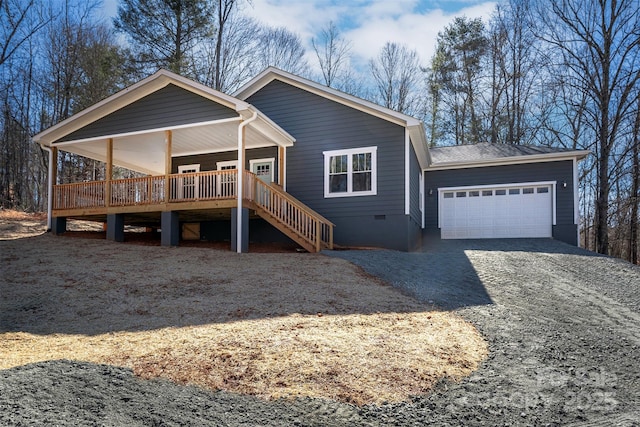 view of front of property featuring driveway, stairway, crawl space, and an attached garage