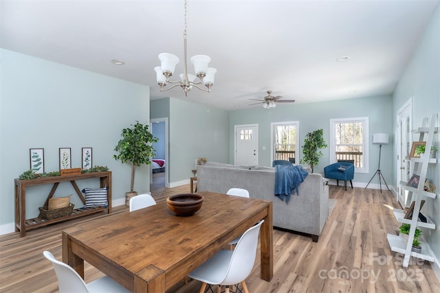 dining area with light wood-style flooring and baseboards