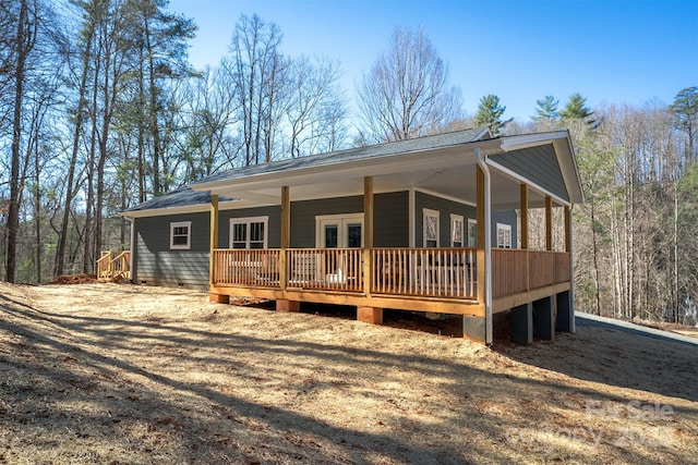 view of front of home featuring driveway, a shingled roof, and a garage