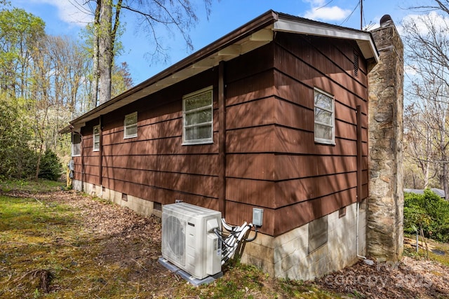 view of home's exterior featuring ac unit and crawl space