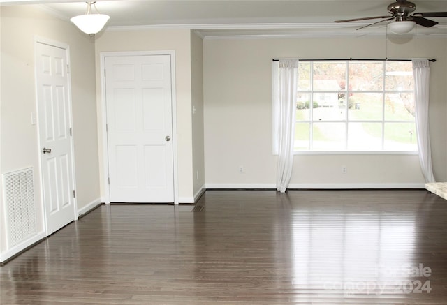 spare room featuring ceiling fan, dark hardwood / wood-style floors, and ornamental molding