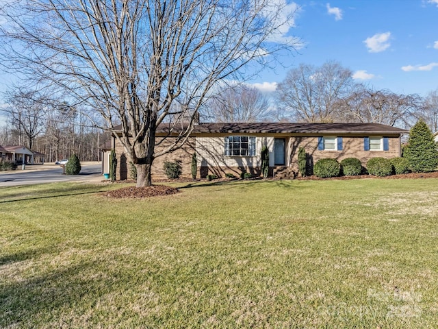 single story home featuring brick siding and a front lawn