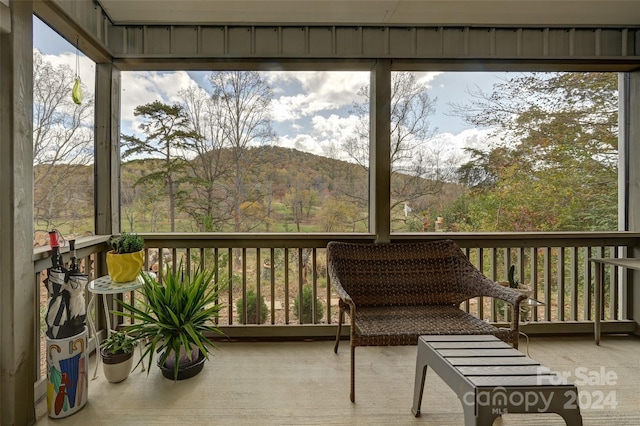 sunroom / solarium featuring a mountain view