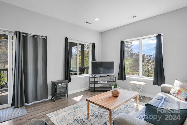 living room with hardwood / wood-style flooring and a wood stove