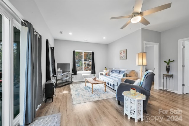 living room featuring ceiling fan and light wood-type flooring