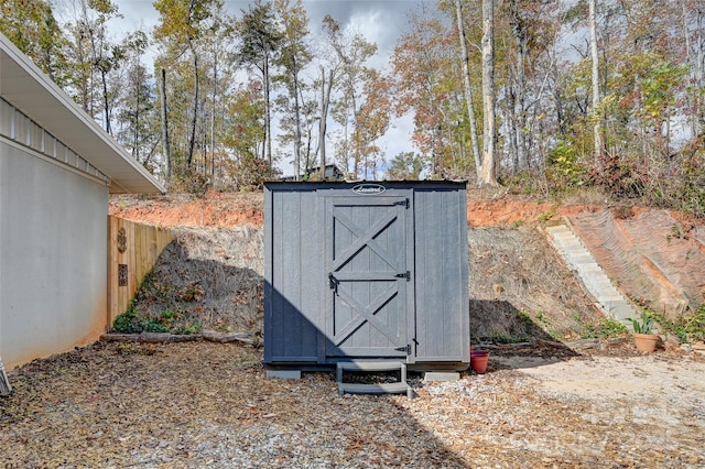 view of shed featuring fence