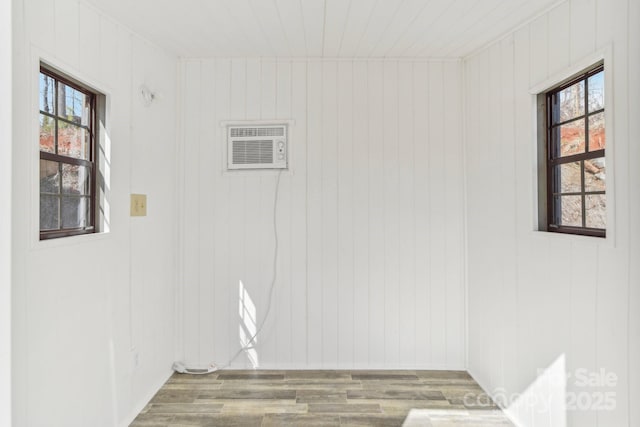 laundry room with visible vents, a wealth of natural light, and wood finished floors