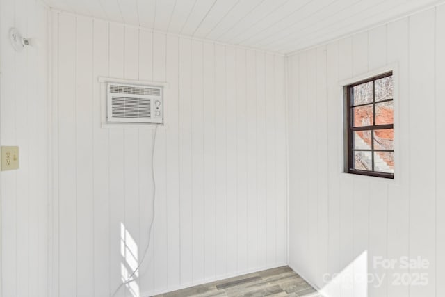 interior space with an AC wall unit and light wood-style floors