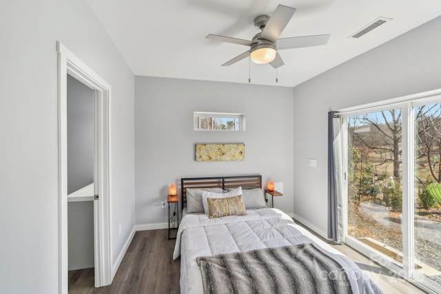 bedroom with ceiling fan, wood finished floors, visible vents, and baseboards