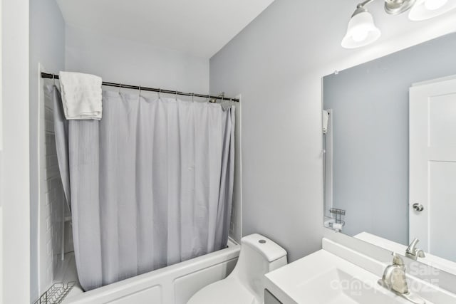 bathroom with shower / tub combo, vanity, and toilet