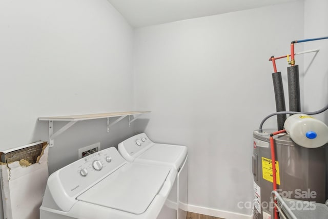 washroom featuring water heater, laundry area, and washing machine and dryer