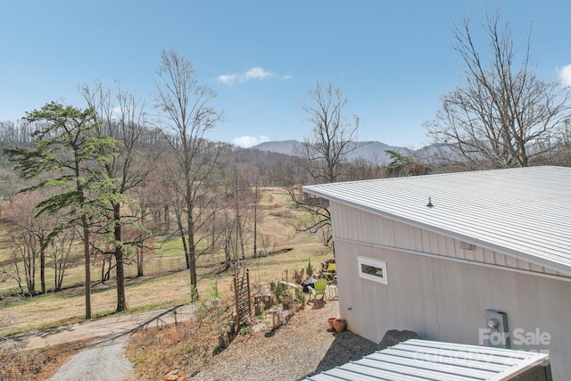 exterior space with metal roof and a mountain view