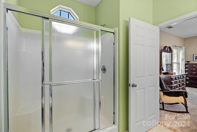 bathroom with a shower with shower door