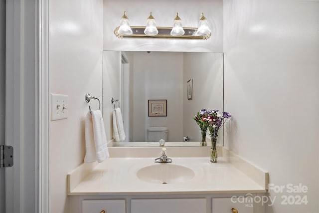 bathroom with vanity and toilet