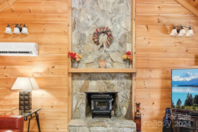 living room featuring beamed ceiling, wooden walls, a wood stove, and a wall mounted AC