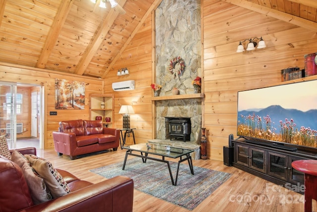 living room featuring hardwood / wood-style flooring, beam ceiling, and a wood stove