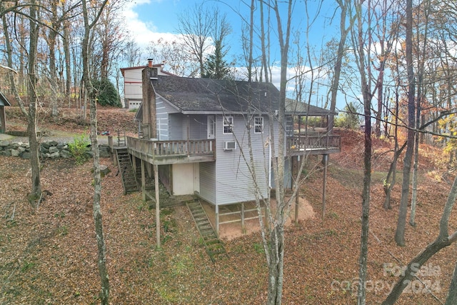 back of house with a wooden deck