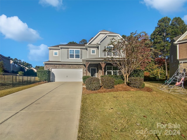 view of front of house featuring a front lawn and a garage