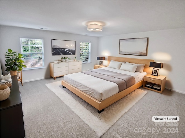 carpeted bedroom featuring multiple windows