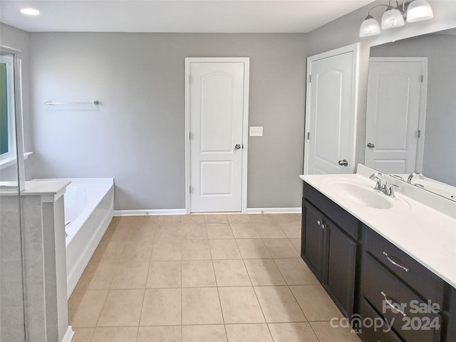 bathroom featuring vanity, a bathtub, and tile patterned flooring