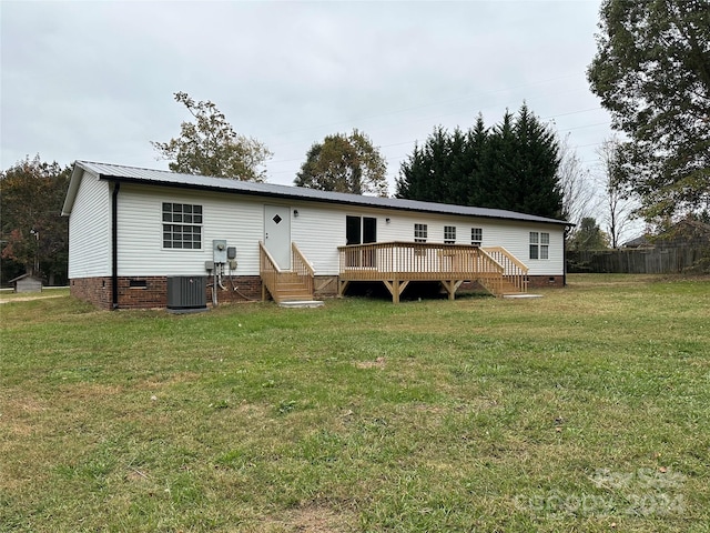 back of house with a wooden deck, cooling unit, and a yard