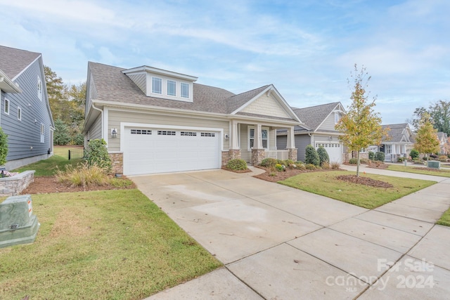 craftsman-style home featuring a garage and a front yard