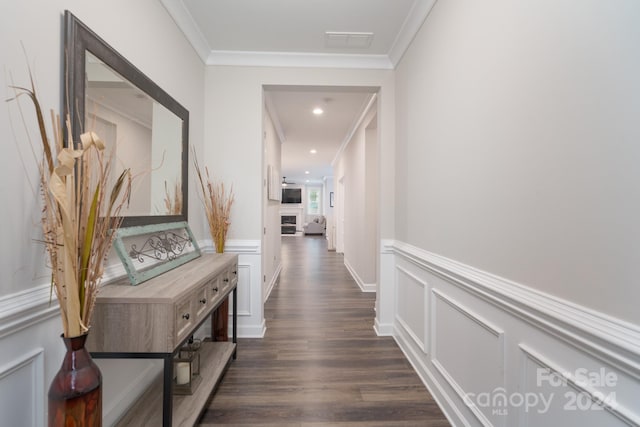 hallway with dark wood-type flooring and crown molding