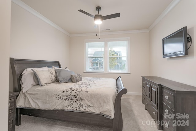 bedroom featuring ceiling fan, light carpet, and crown molding