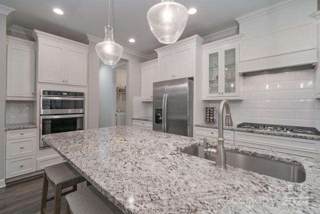 kitchen with stainless steel appliances, dark hardwood / wood-style flooring, pendant lighting, and decorative backsplash