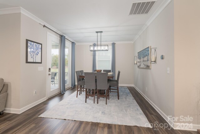 dining area featuring crown molding and dark hardwood / wood-style flooring