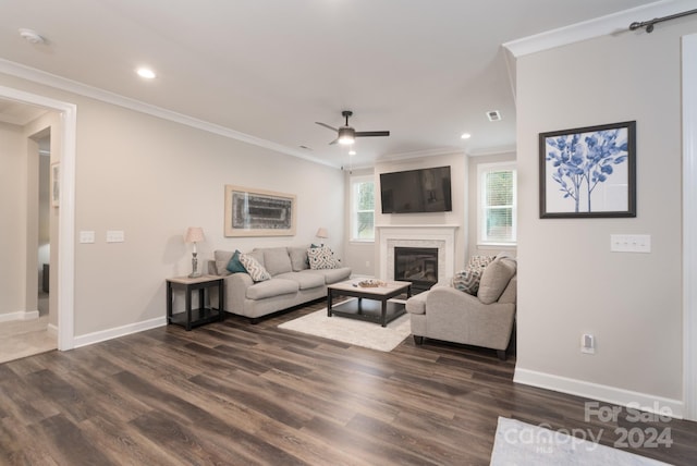 living room with ornamental molding, a fireplace, dark hardwood / wood-style floors, and ceiling fan