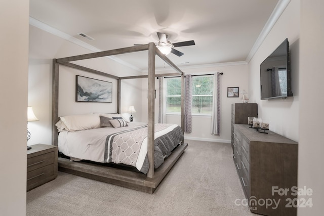 bedroom with light colored carpet, ceiling fan, and crown molding