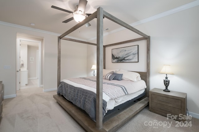 carpeted bedroom with ceiling fan and crown molding