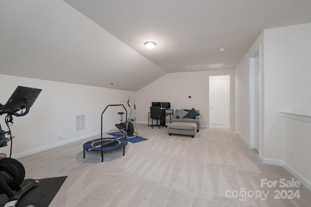 workout room featuring light carpet and lofted ceiling