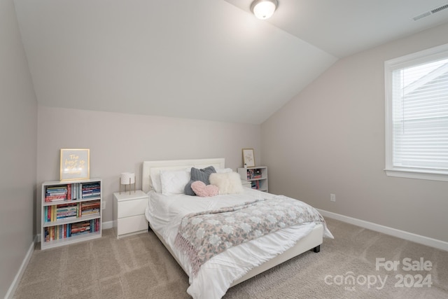 carpeted bedroom featuring vaulted ceiling