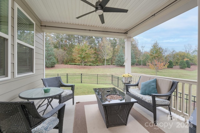 view of patio with an outdoor living space with a fire pit and ceiling fan