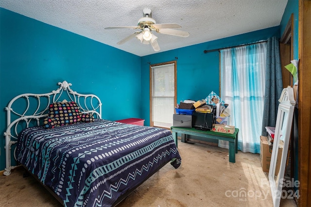 bedroom featuring a textured ceiling, carpet, and ceiling fan