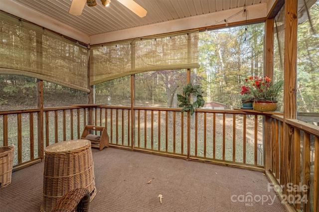 unfurnished sunroom featuring ceiling fan and wooden ceiling